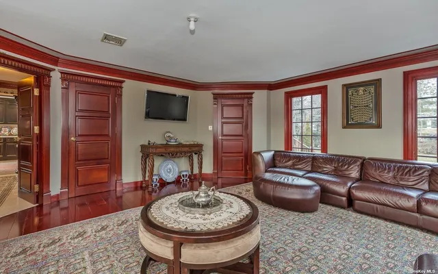 a living room with furniture a rug and a flat screen tv