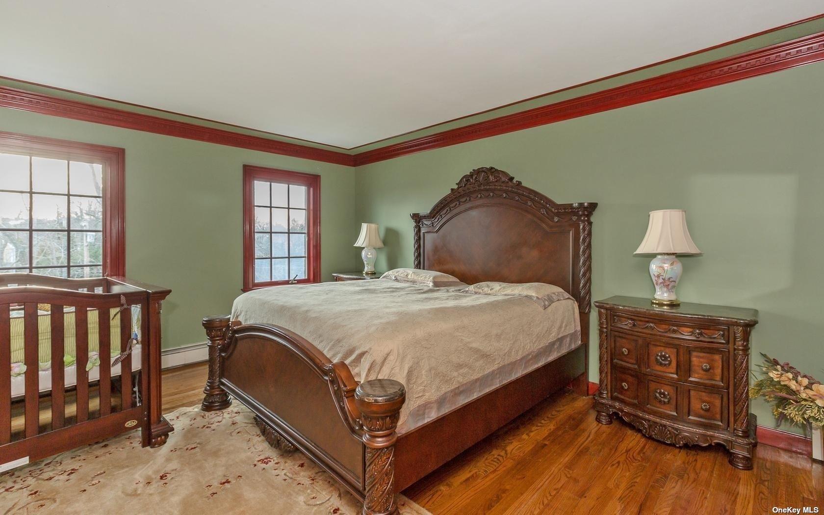 7 Old Field Road Setauket, NY 11733 - Photo 21 of 33 a bed sitting in a bedroom next to a window