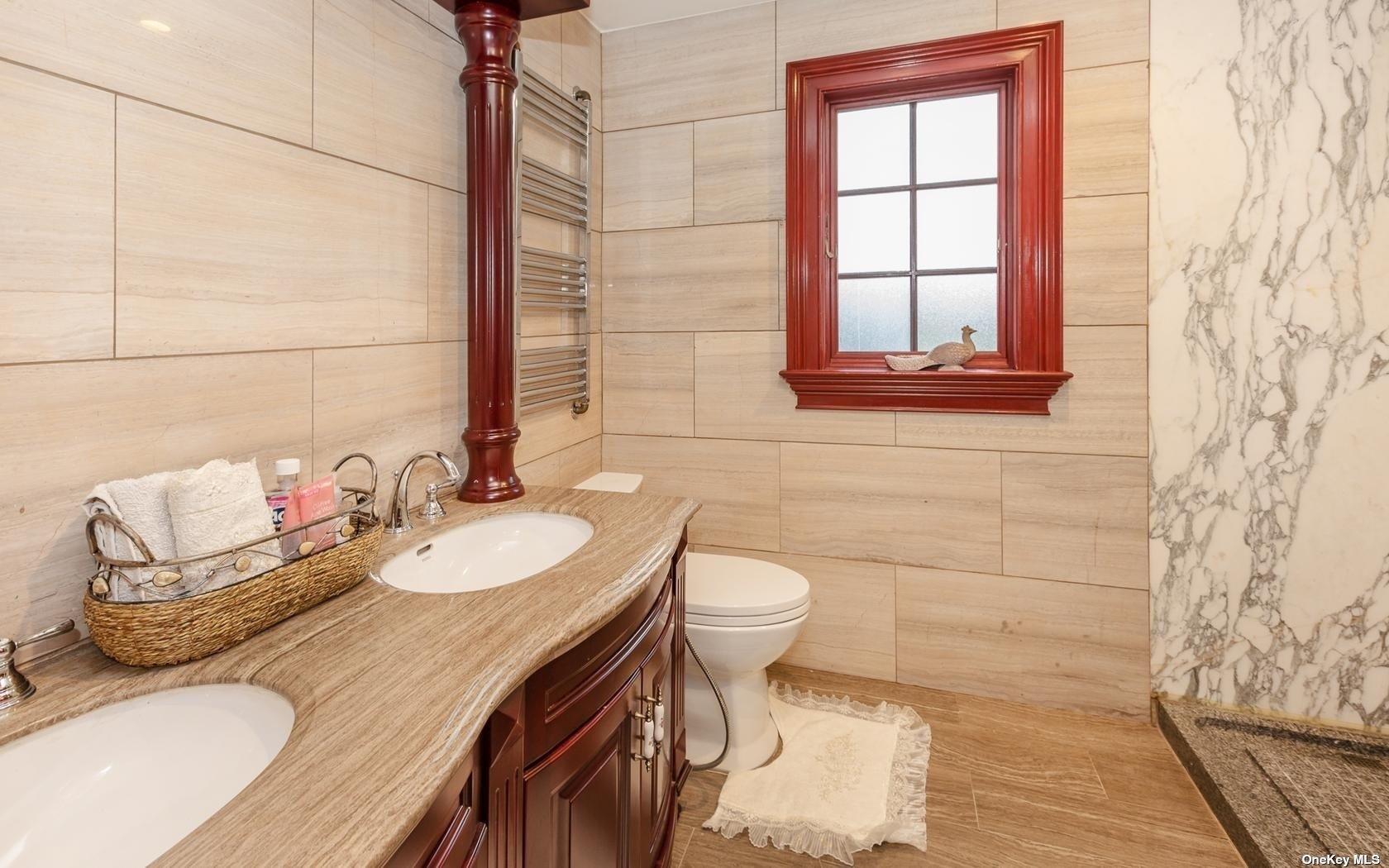 7 Old Field Road Setauket, NY 11733 - Photo 25 of 33 a bathroom with a granite countertop sink a toilet and mirror