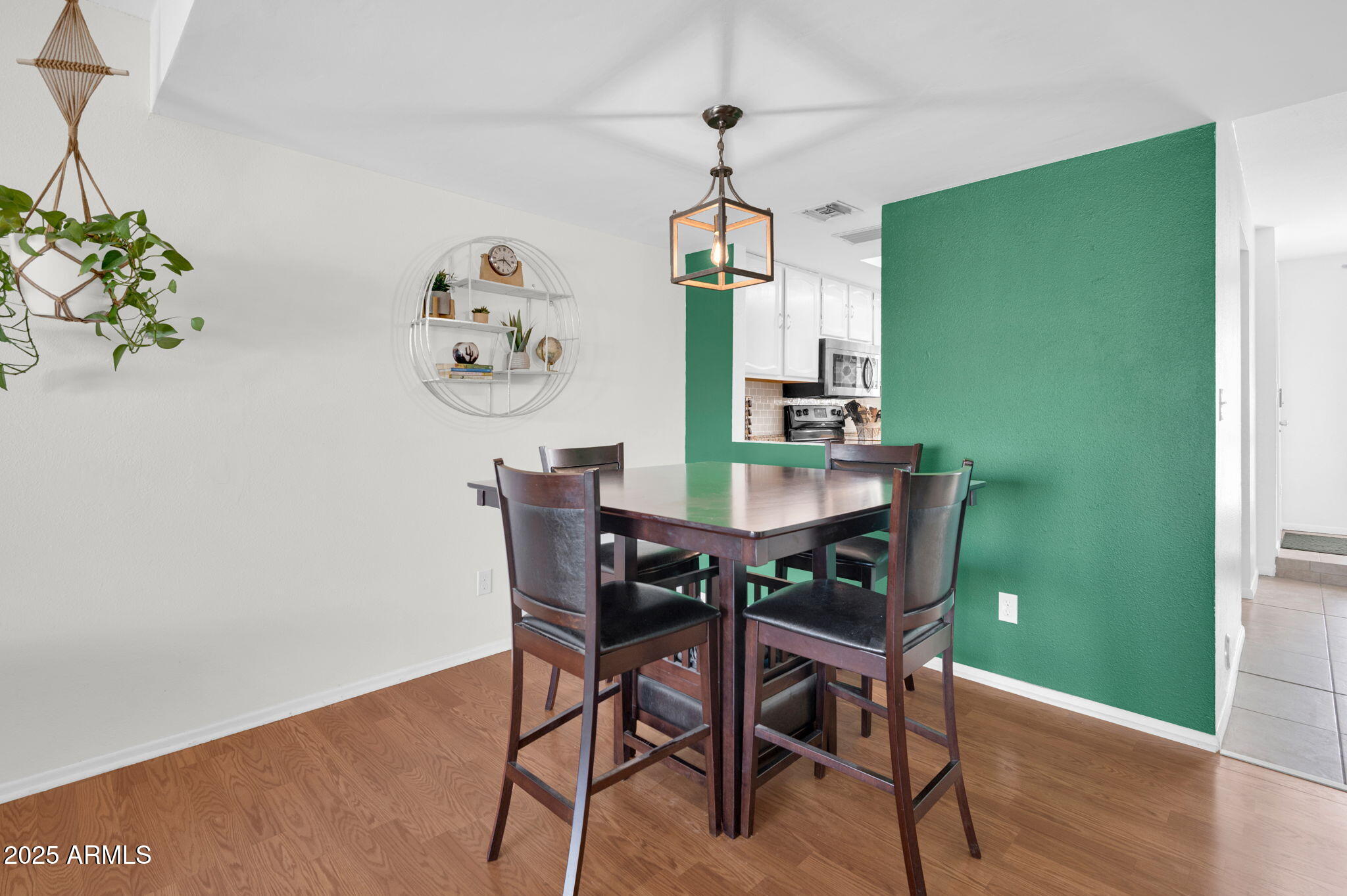 5315 North 18th Street, Unit 9 Phoenix, AZ 85016 - Photo 9 of 27 a view of a dining room with furniture wooden floor and a chandelier