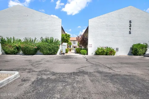 a view of a chairs and table in the balcony