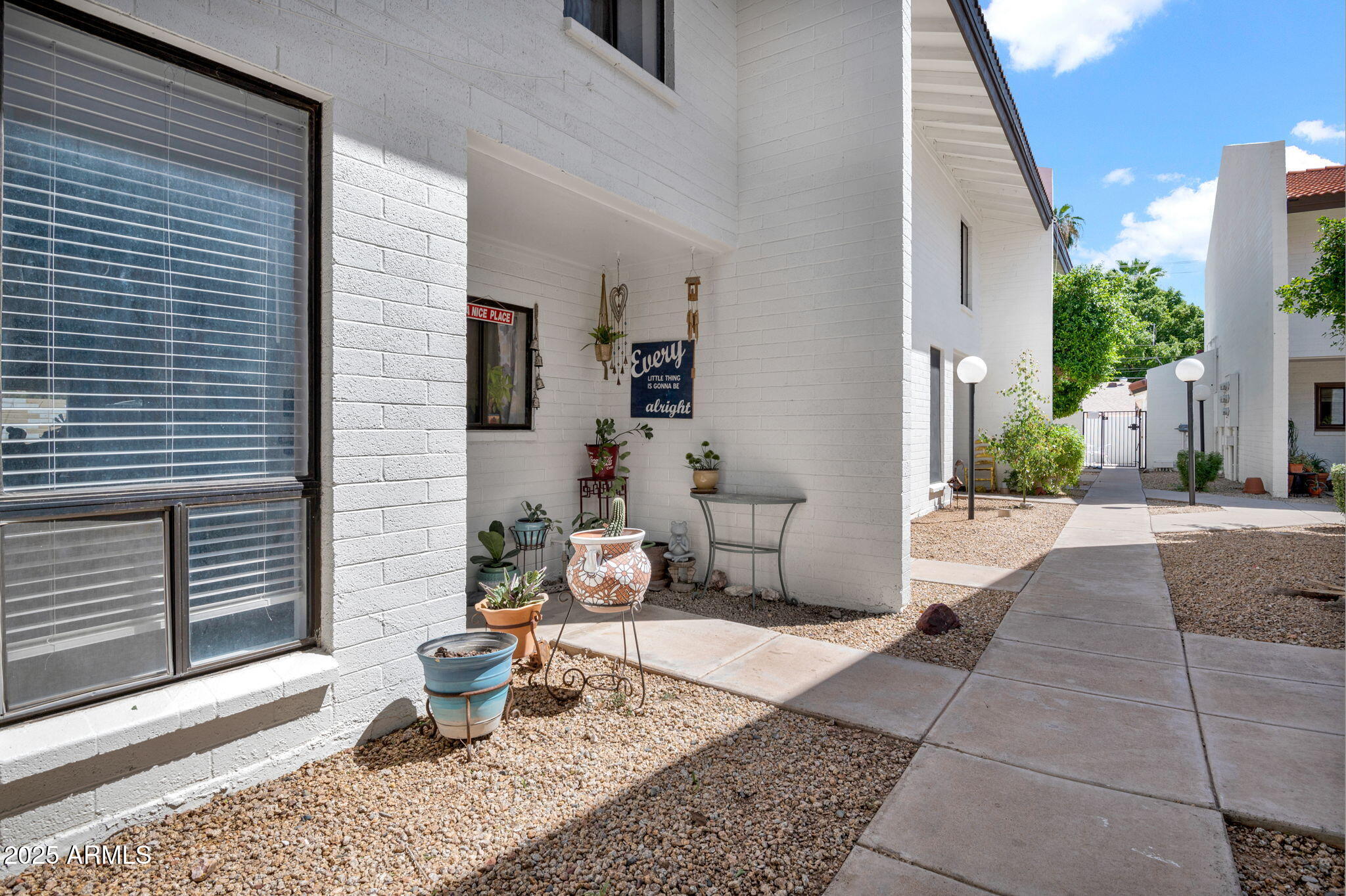 5315 North 18th Street, Unit 9 Phoenix, AZ 85016 - Photo 3 of 27 a view of a patio with table and chairs and potted plants