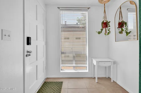 a view of a patio with table and chairs and potted plants