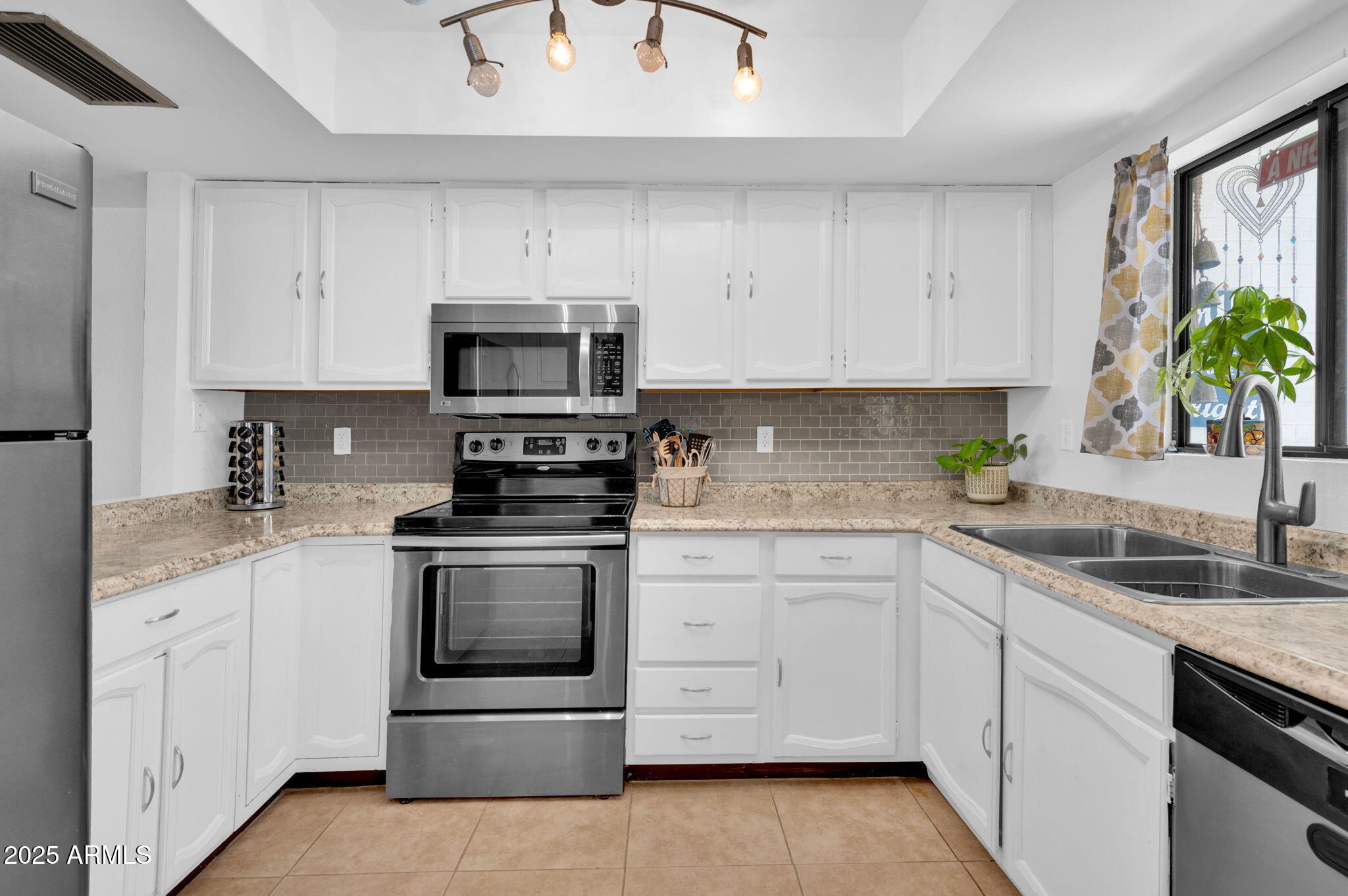 5315 North 18th Street, Unit 9 Phoenix, AZ 85016 - Photo 5 of 27 a kitchen with white cabinets appliances and a sink