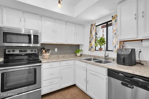 a kitchen with stainless steel appliances a refrigerator stove and microwave