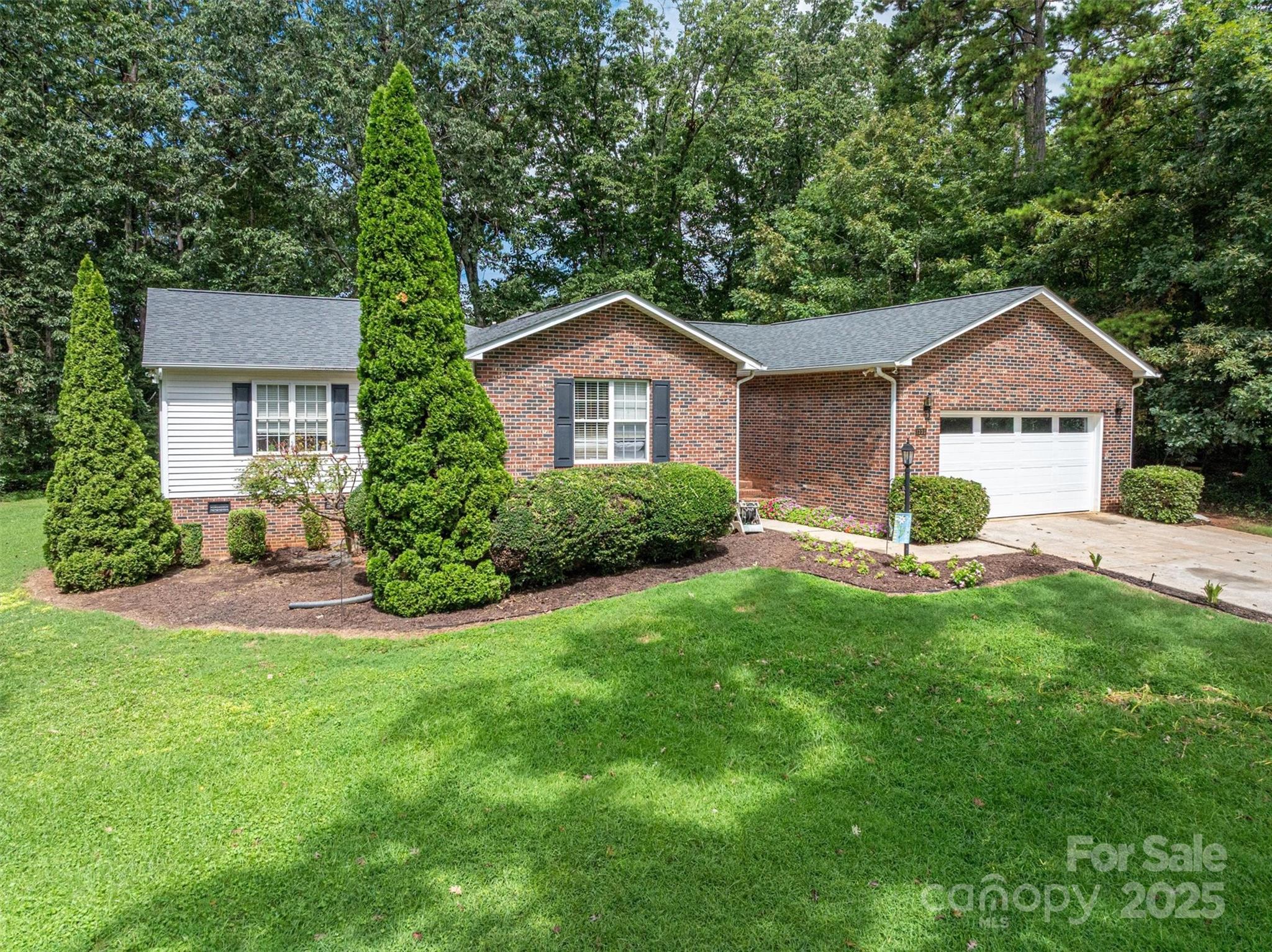 1335 Huckleberry Road Lincolnton, NC 28092 - Photo 1 of 24 a house view with a garden space