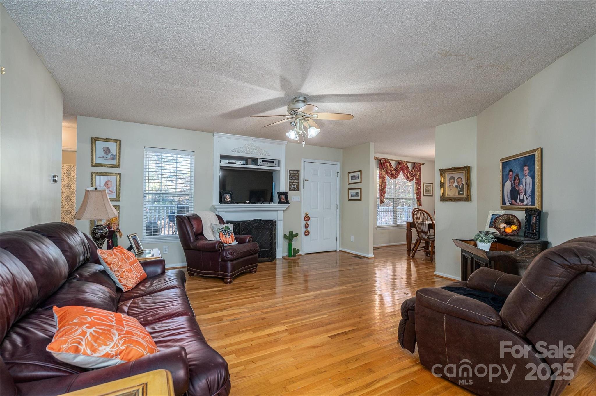 1335 Huckleberry Road Lincolnton, NC 28092 - Photo 2 of 24 a living room with furniture a flat screen tv and kitchen view