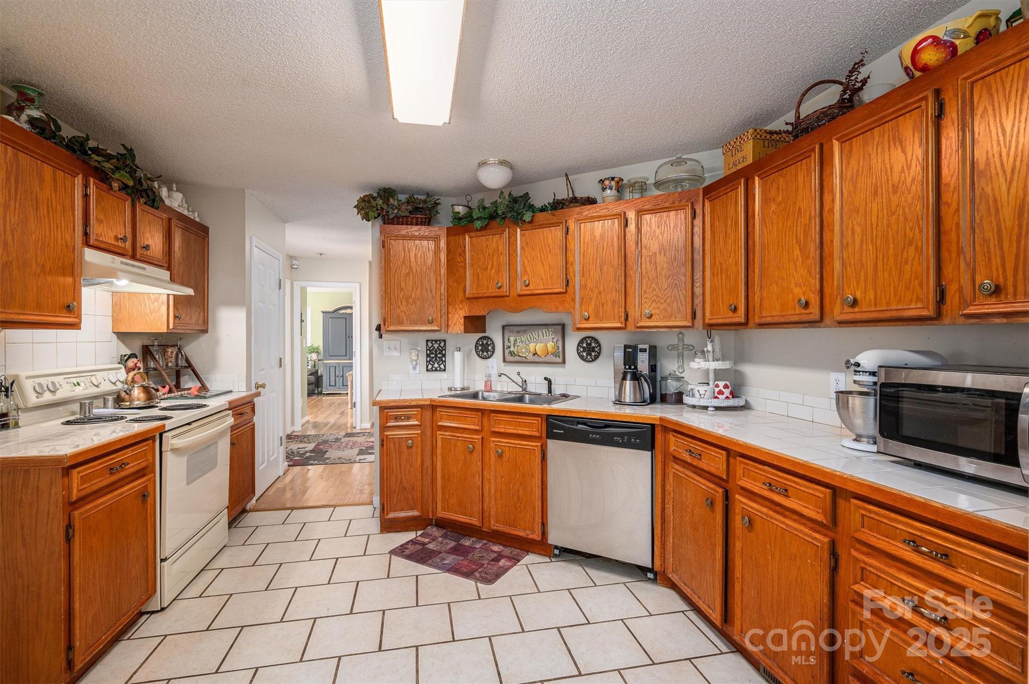 1335 Huckleberry Road Lincolnton, NC 28092 - Photo 5 of 24 a kitchen with stainless steel appliances granite countertop a stove a sink dishwasher and a microwave oven on the blue kitchen countertops