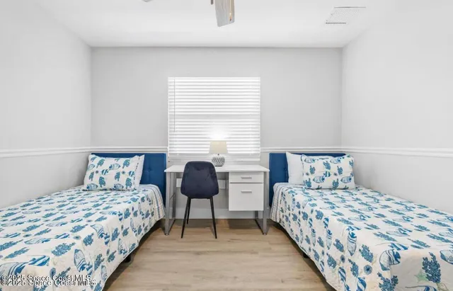 a bedroom with a bed and a lamp