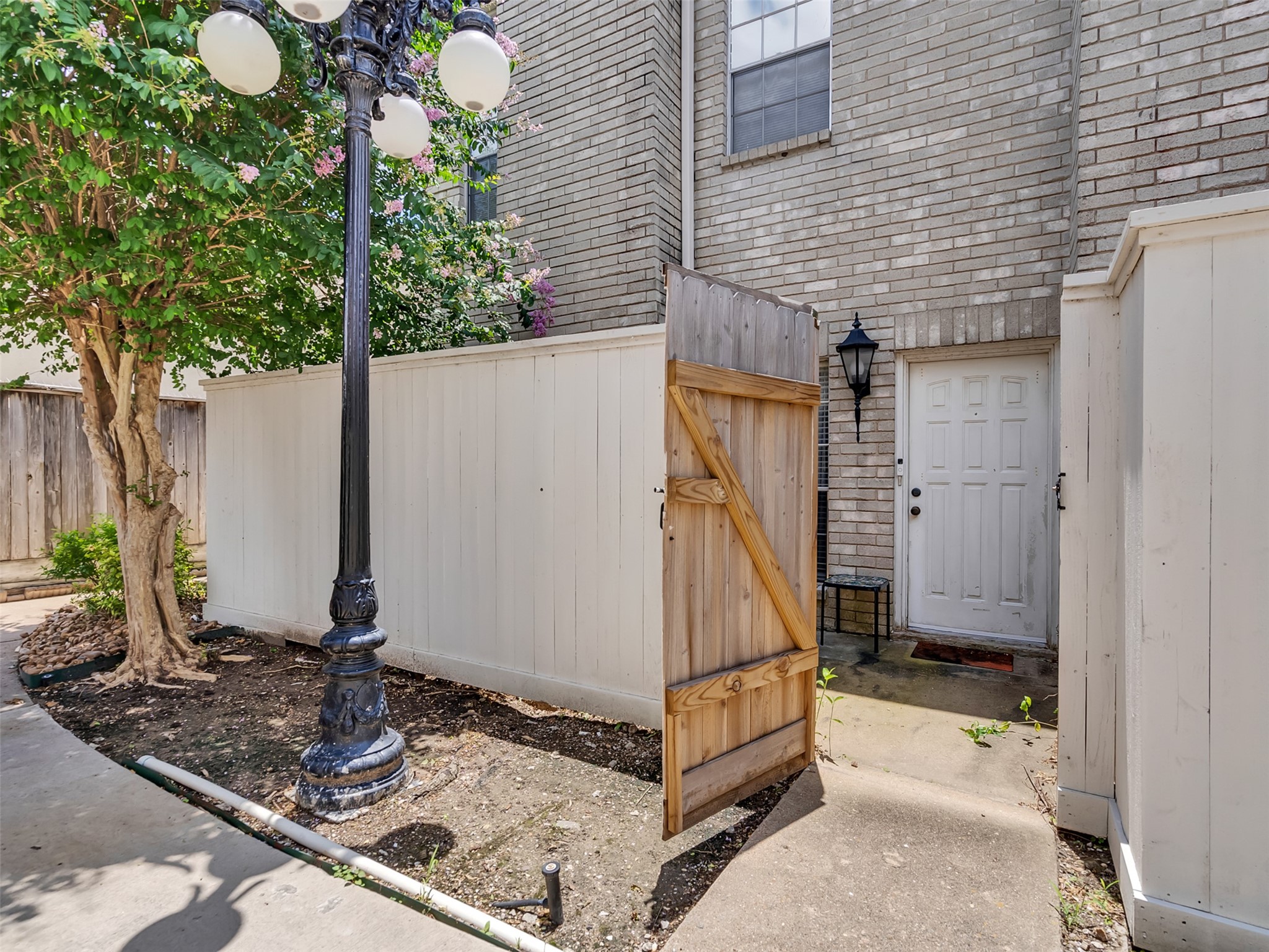 4001 Tanglewilde Street, Unit 605 Houston, TX 77063 - Photo 3 of 29 a front view of a house with garden