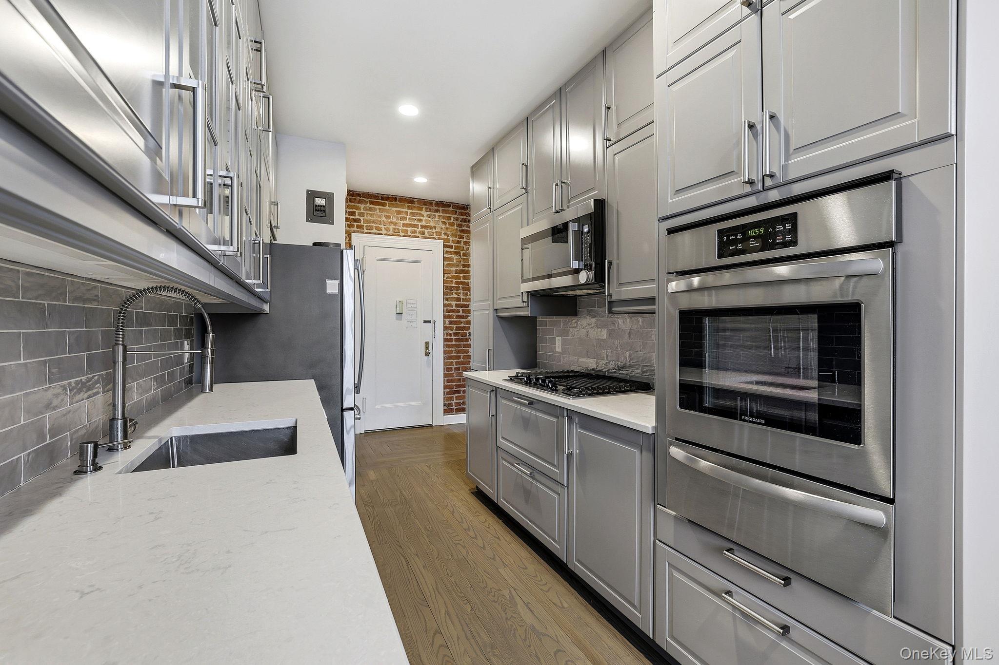 11 Alden Road, Unit 1M Larchmont, NY 10538 - Photo 11 of 25 a kitchen with stainless steel appliances granite countertop a stove and a refrigerator