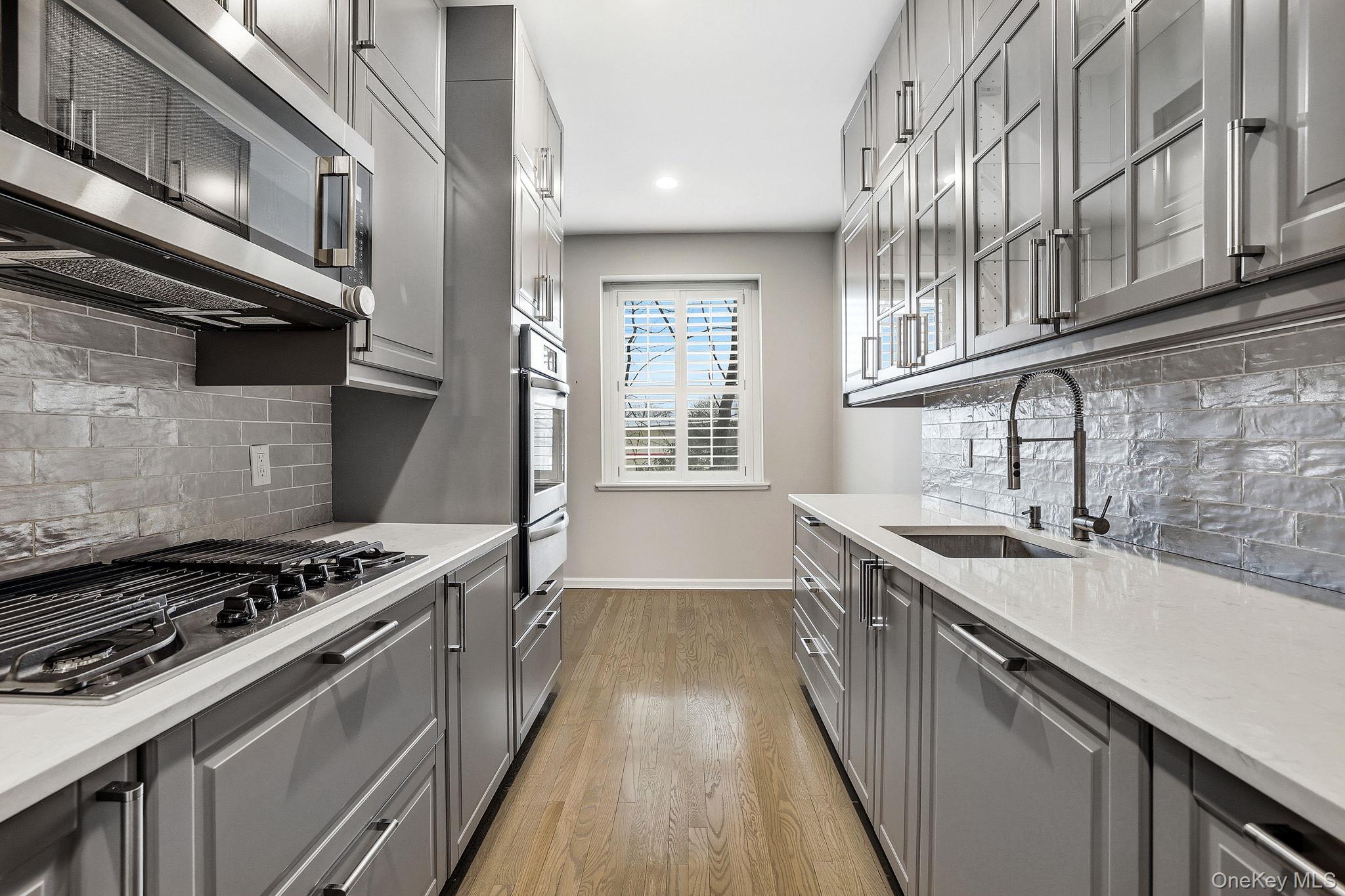 11 Alden Road, Unit 1M Larchmont, NY 10538 - Photo 12 of 25 a kitchen with stainless steel appliances granite countertop a stove and a sink