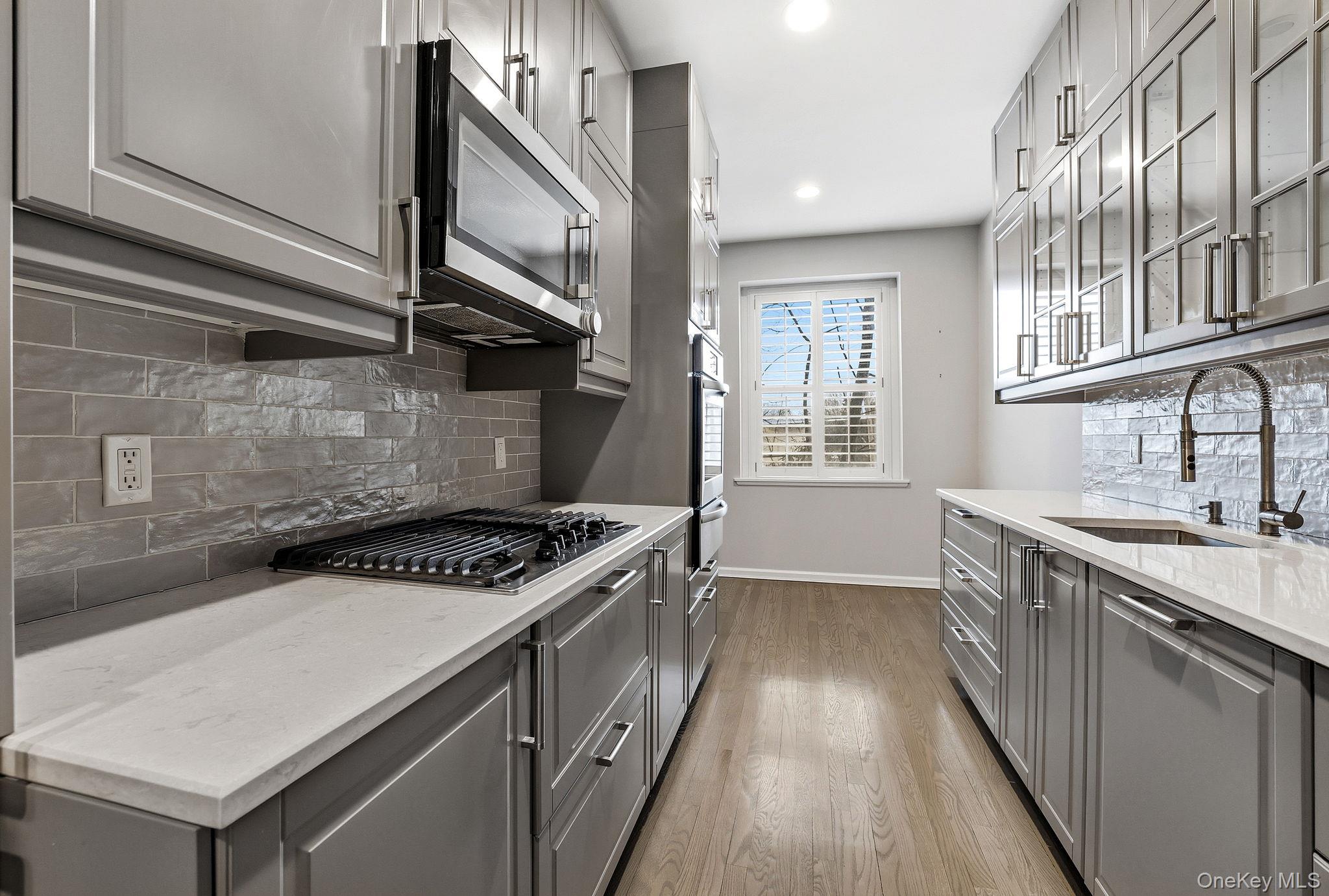 11 Alden Road, Unit 1M Larchmont, NY 10538 - Photo 13 of 25 a kitchen with a stove and a sink