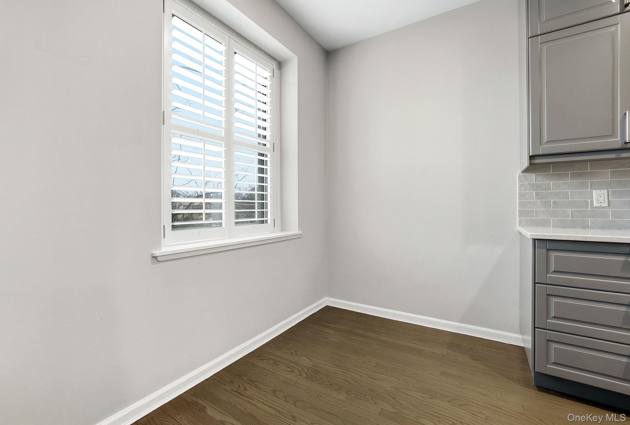 11 Alden Road, Unit 1M Larchmont, NY 10538 - Photo 16 of 25 a view of an empty room with wooden floor and a window