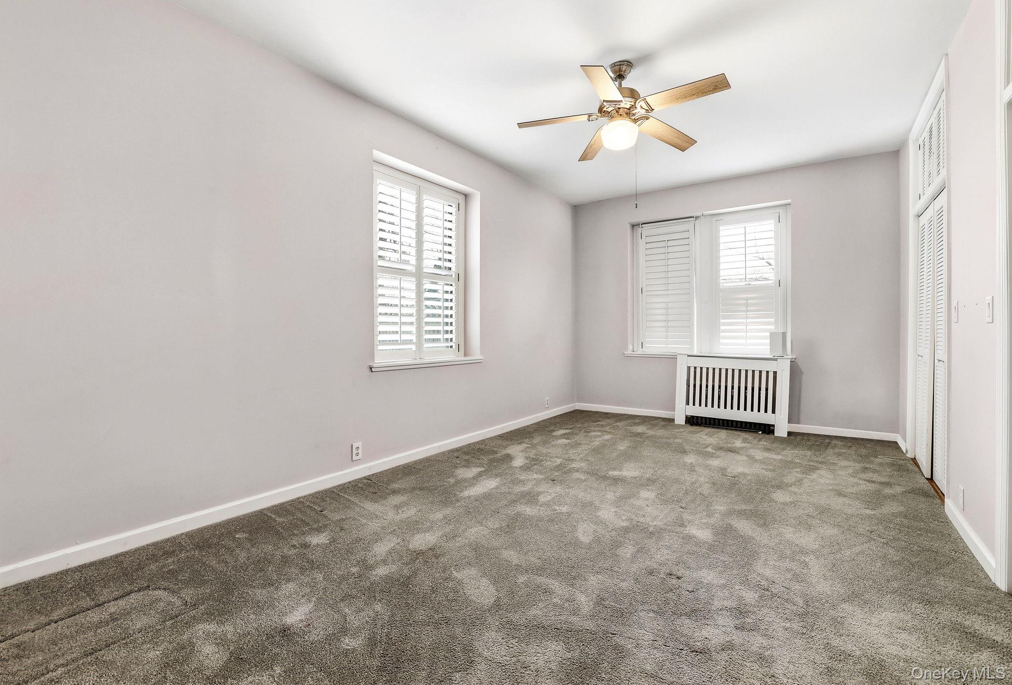 11 Alden Road, Unit 1M Larchmont, NY 10538 - Photo 18 of 25 an empty room with chandelier fan and windows