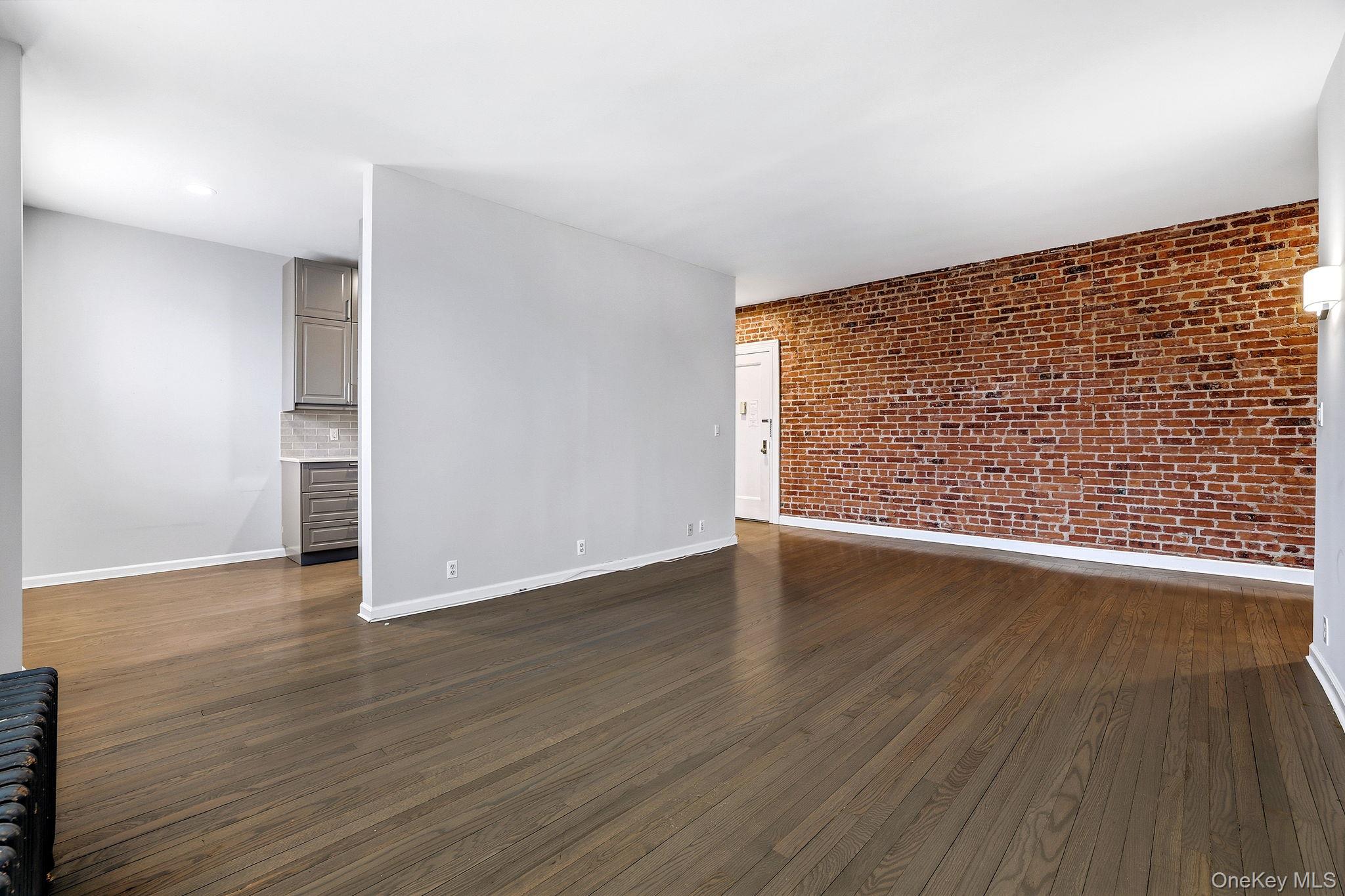11 Alden Road, Unit 1M Larchmont, NY 10538 - Photo 8 of 25 a view of an empty room with wooden floor and a window