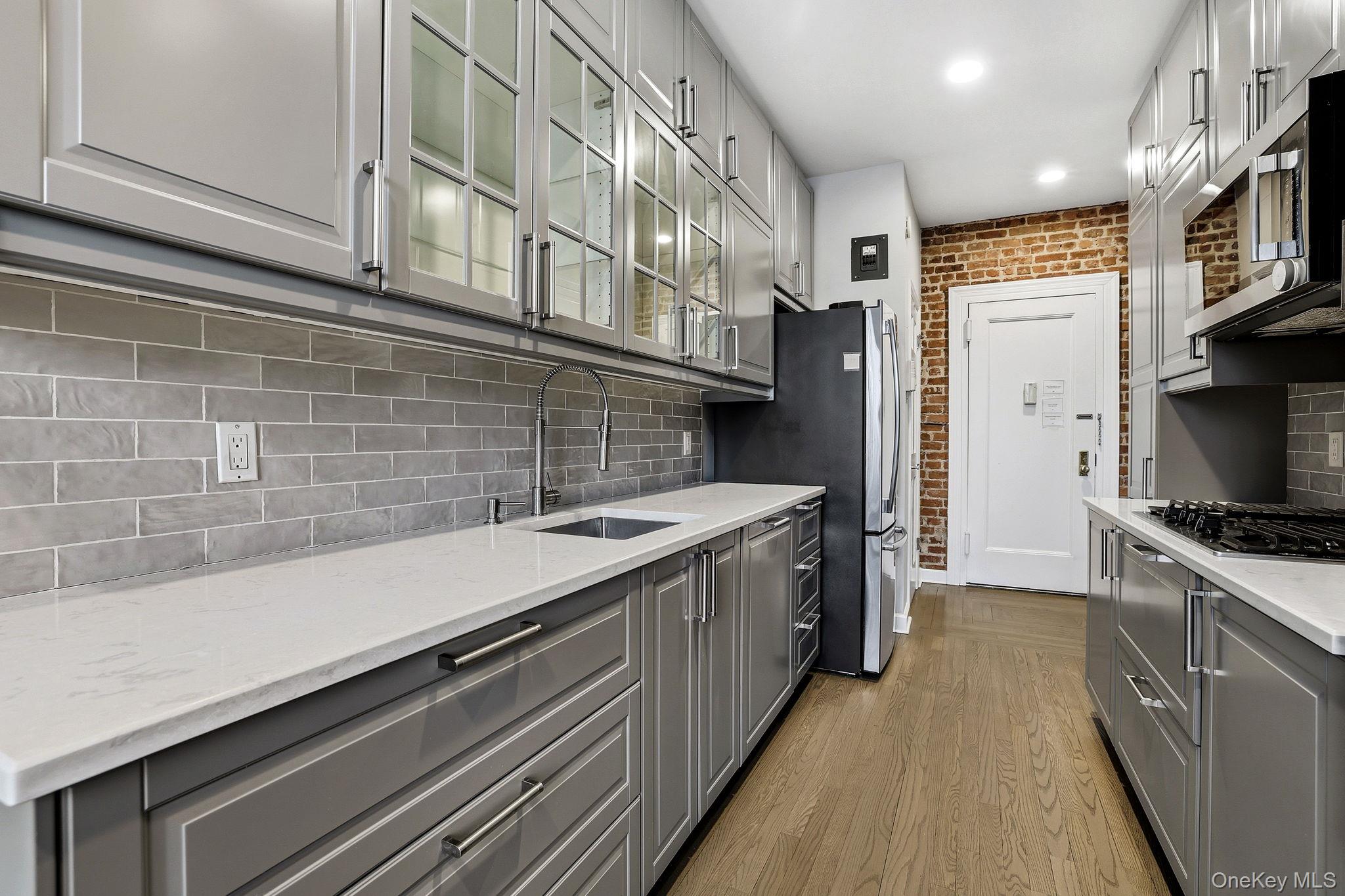 11 Alden Road, Unit 1M Larchmont, NY 10538 - Photo 10 of 25 a kitchen with a sink and a stove top oven
