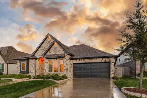 a kitchen with stainless steel appliances a dining table chairs and wooden floor