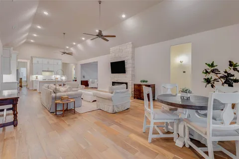 a view of a big house with a big yard and large trees