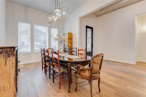 a spacious bedroom with a bed and a chandelier