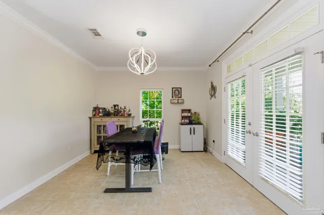 a bedroom with a bed bookshelf and a large window