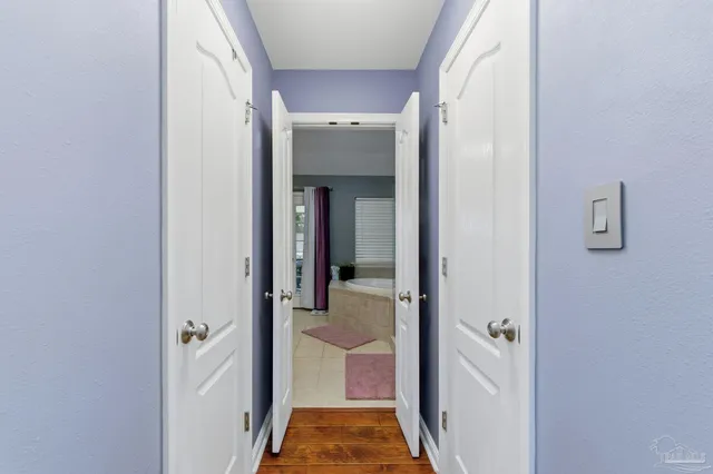 a bathroom with a bathtub and potted plant