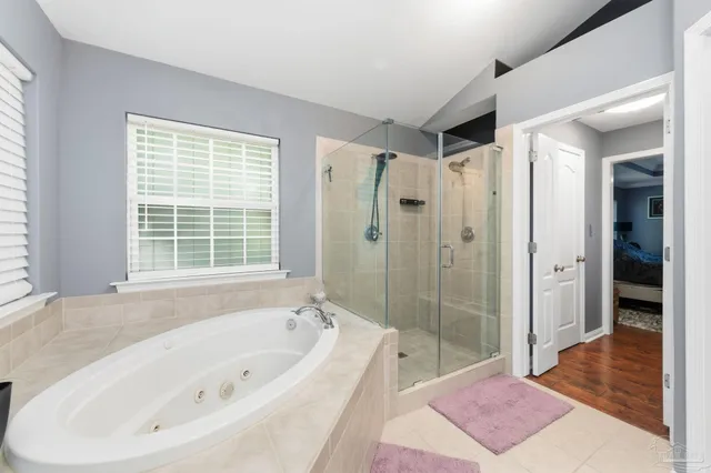 a bathroom with a shower and a bath tub
