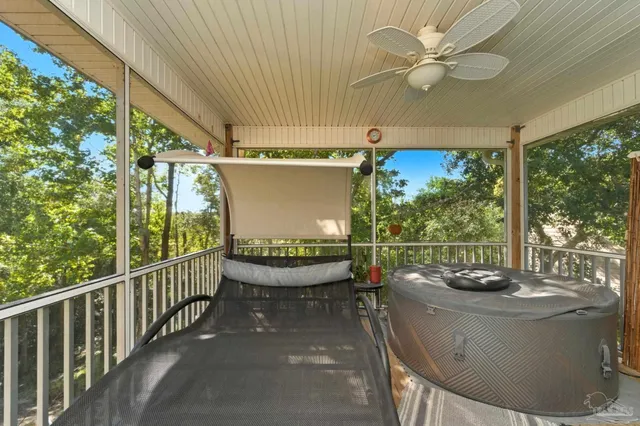 a view of balcony with wooden floor and potted plant