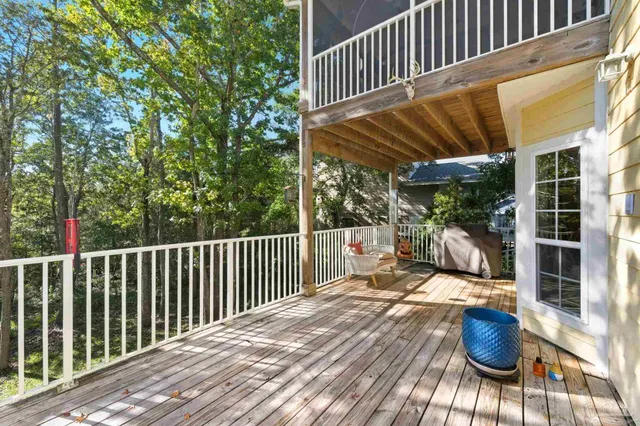 a view of balcony with wooden floor and fence