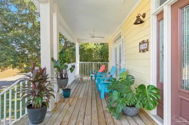 a front view of a house with a garden and trees