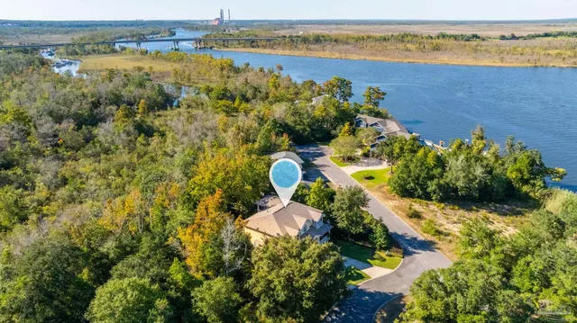 a aerial view of a house with a garden and lake view