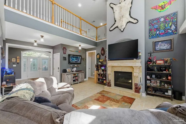 a living room with furniture a flat screen tv and a fireplace