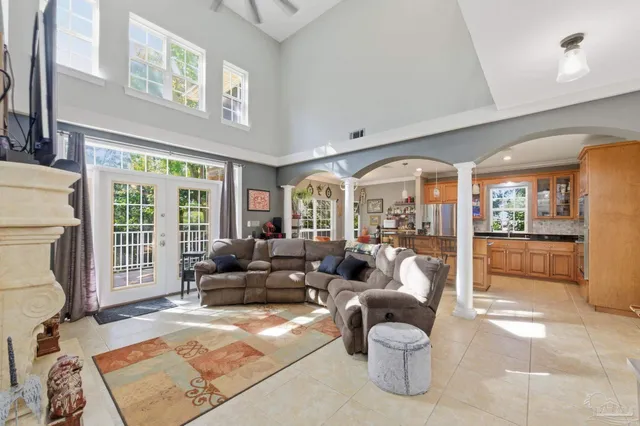 a living room with furniture and large windows
