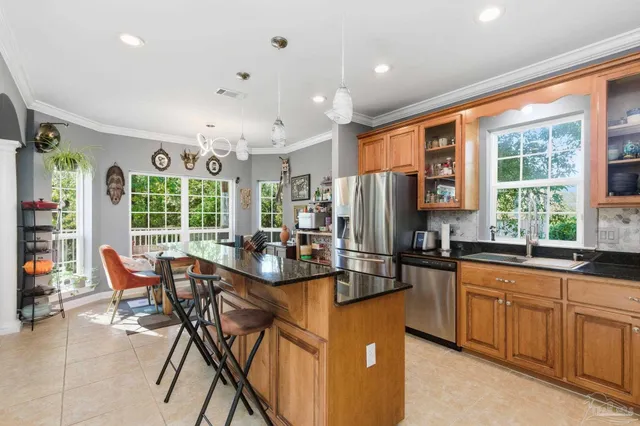 a kitchen with stainless steel appliances granite countertop a refrigerator and a stove top oven
