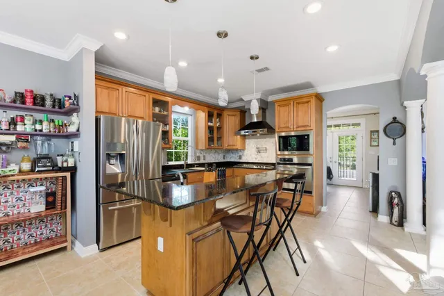 a kitchen with stainless steel appliances granite countertop a refrigerator and a sink
