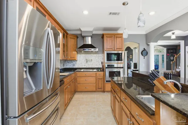 a kitchen with granite countertop a stove and a sink