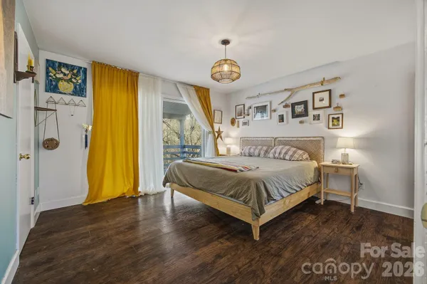 a spacious bedroom with a bed and a table in it