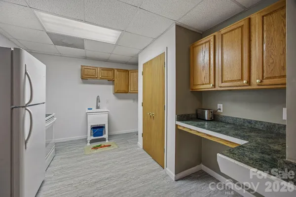a kitchen with granite countertop wooden cabinets a sink a stove and stainless steel appliances