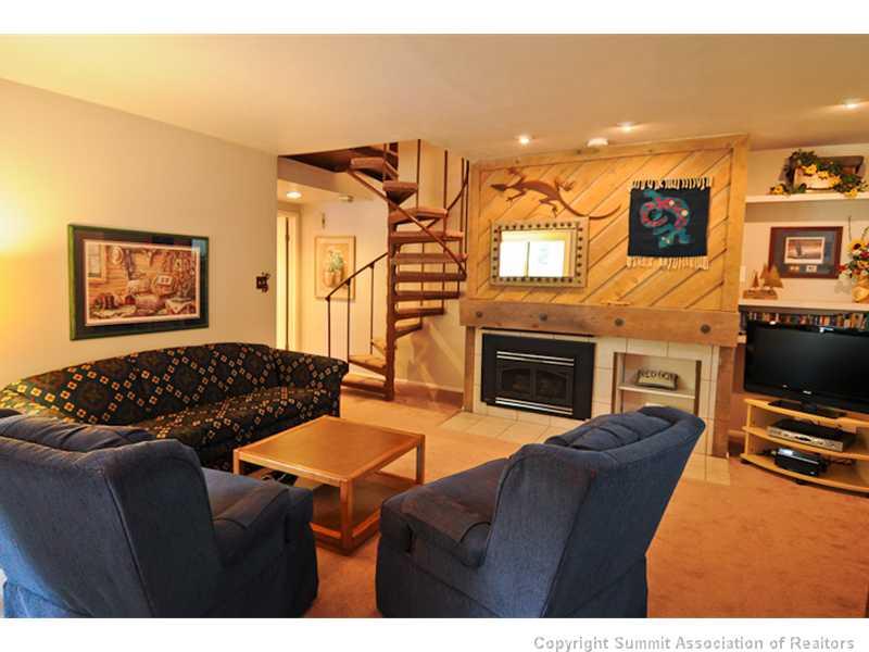 1977 Soda Ridge Road, Unit 1212 Keystone, CO 80435 - Photo 2 of 25 a living room with furniture a flat screen tv and a fireplace