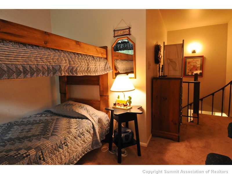 1977 Soda Ridge Road, Unit 1212 Keystone, CO 80435 - Photo 17 of 25 a bedroom with a bed and a view of en suite