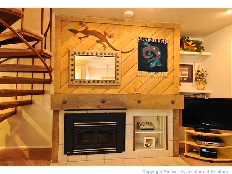1977 Soda Ridge Road, Unit 1212 Keystone, CO 80435 - Photo 5 of 25 a living room with a fireplace and a flat screen tv
