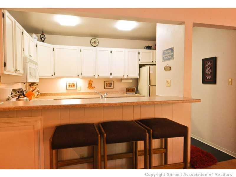 1977 Soda Ridge Road, Unit 1212 Keystone, CO 80435 - Photo 7 of 25 a kitchen with a table and chairs