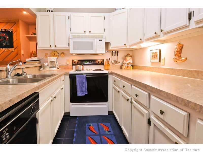 1977 Soda Ridge Road, Unit 1212 Keystone, CO 80435 - Photo 8 of 25 a kitchen with stainless steel appliances granite countertop a stove and a sink