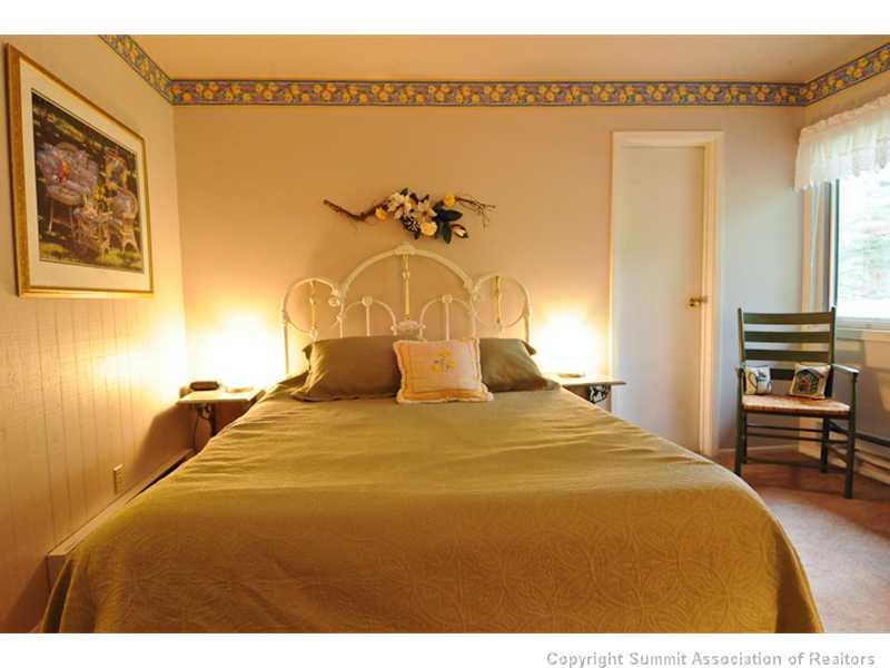 1977 Soda Ridge Road, Unit 1212 Keystone, CO 80435 - Photo 10 of 25 a bedroom with a bed and a chandelier