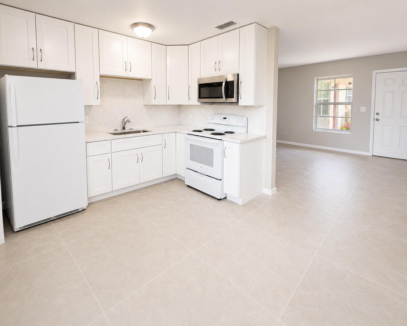 a kitchen with white cabinets and white appliances