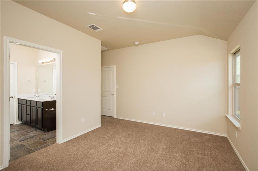 12912 Tinker Street Manor, TX 78653 - Photo 12 of 12 an empty room with kitchen view and a sink