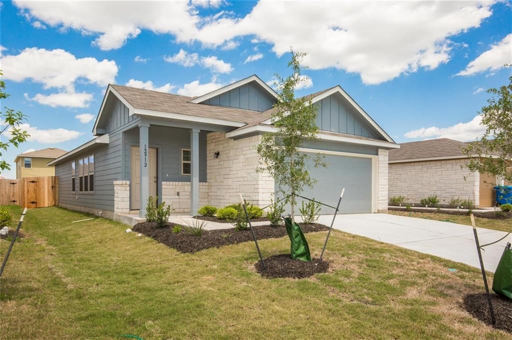 12912 Tinker Street Manor, TX 78653 - Photo 2 of 12 a front view of a house with garden