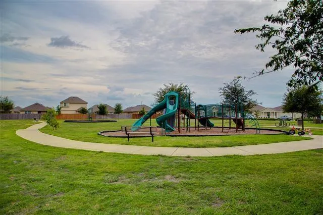 a view of a park with swings and slides