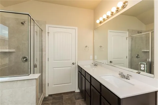 a bathroom with a sink double vanity and a mirror