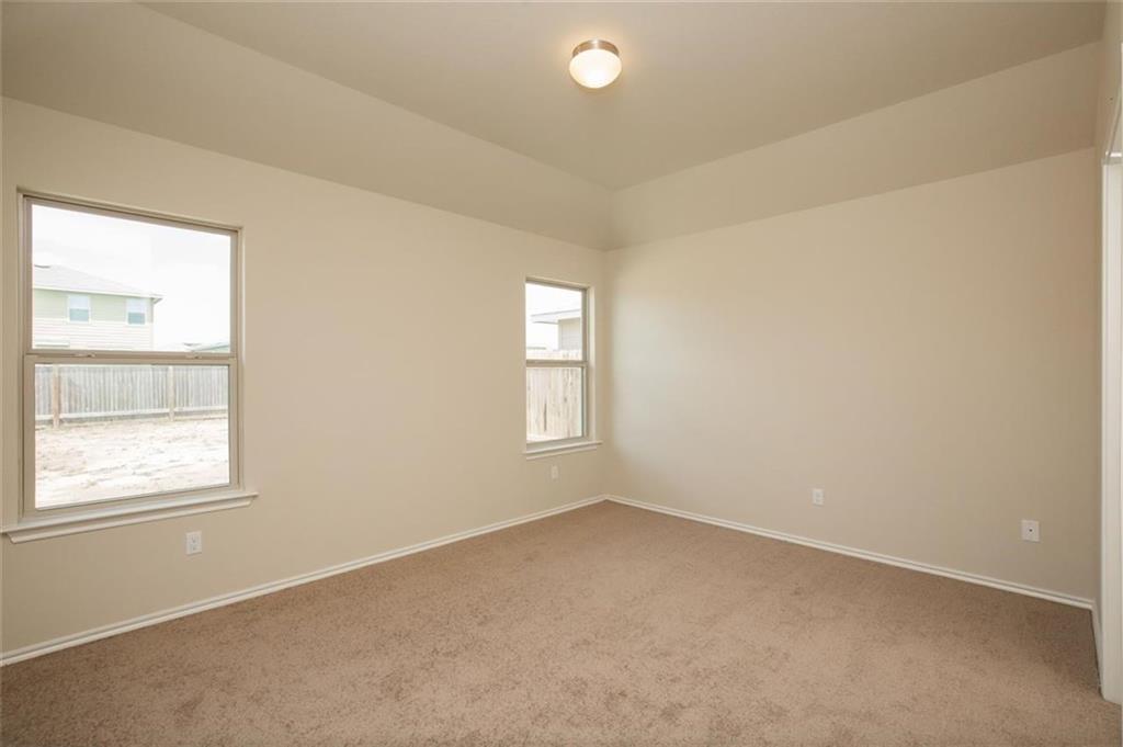 12912 Tinker Street Manor, TX 78653 - Photo 9 of 12 an empty room with windows
